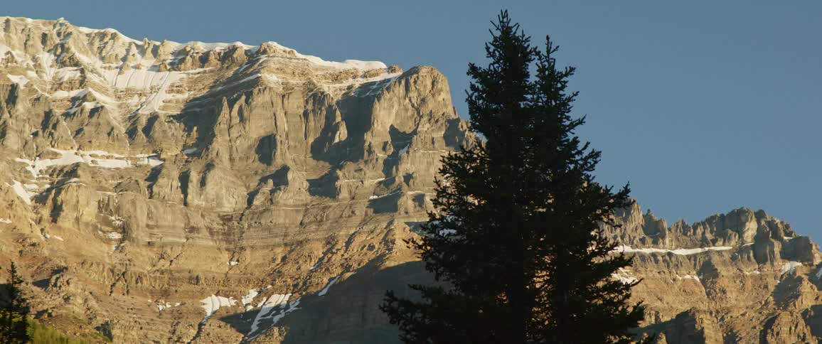A stone mountain ridge under a clear deep blue sky