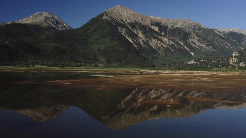 A mountain is reflected in a large lake in nature