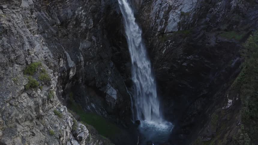 Waterfall flowing through mountains