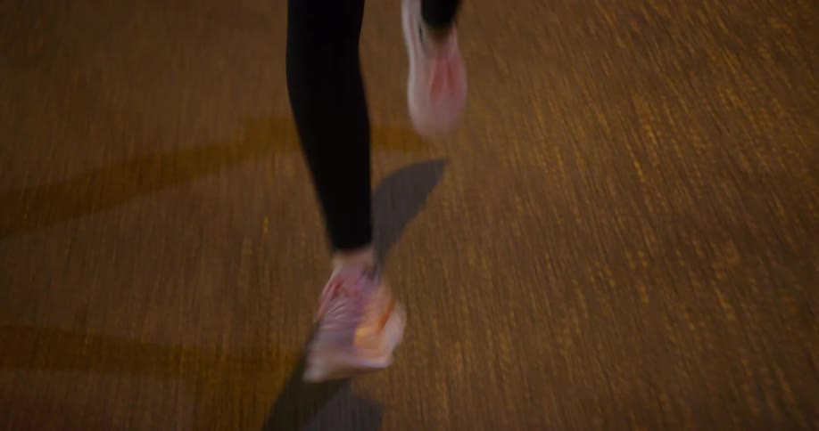Young fit woman jogging on the city streets at night