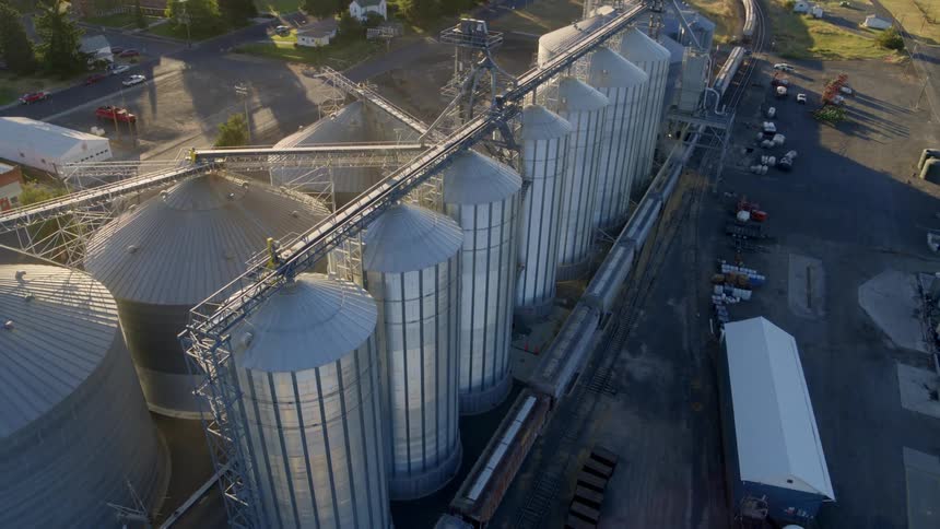 Tilt down ascent of a small town grain handling facility transferring wheat into rail cars