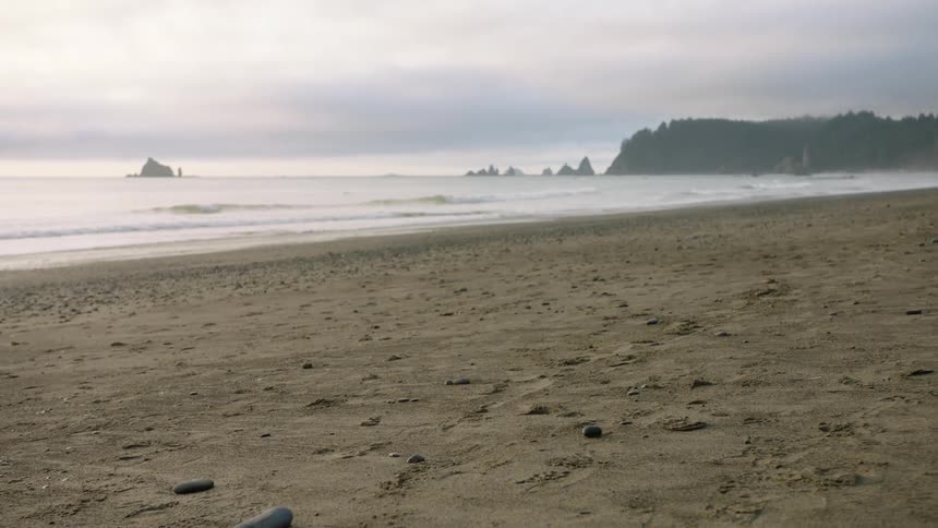 A sandy beach under a cloudy daytime sky