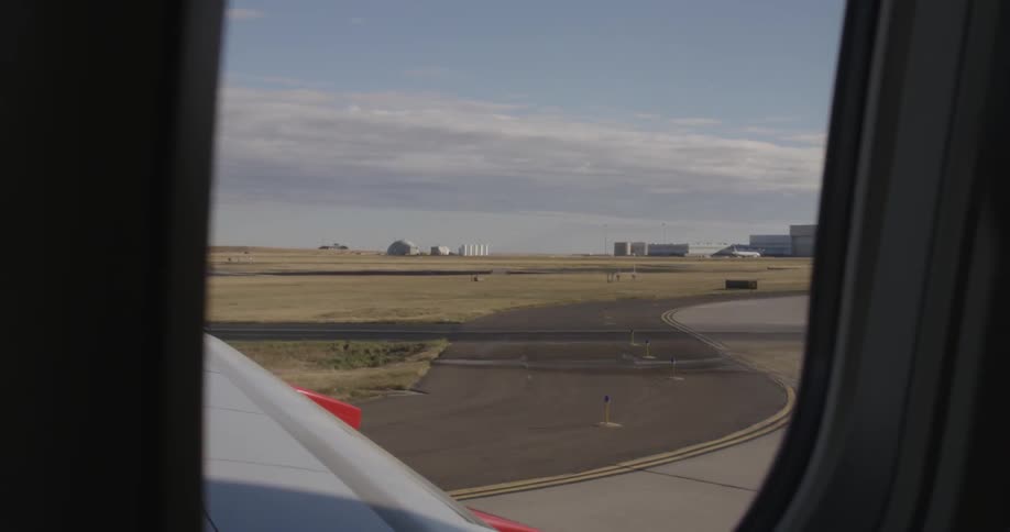 Looking out of an airplane window as the airplane takes off