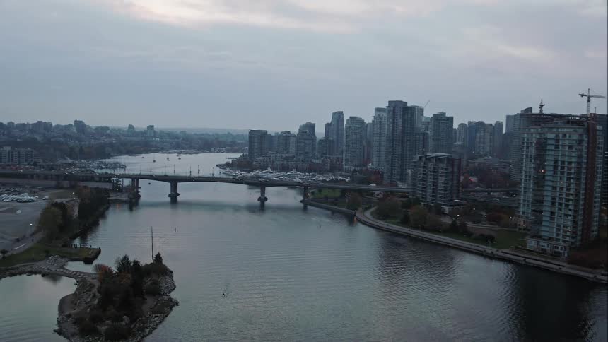 An aerial view of a bridge into downtown Vancouver with skyscrapers