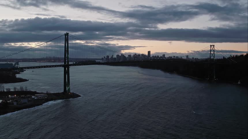 Lions Gate Bridge with choppy ocean water and Vancouver skyline in distance