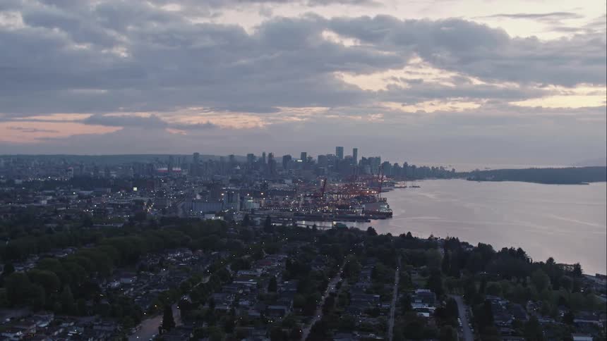 Aerial view of distant high rise buildings of downtown Vancouver at dusk