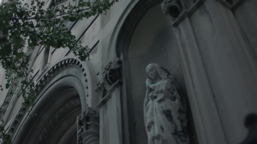A statue of a woman in the arch of a building
