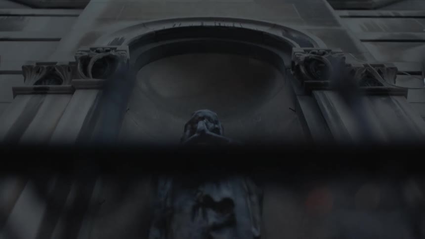 A statue stands outside a church
