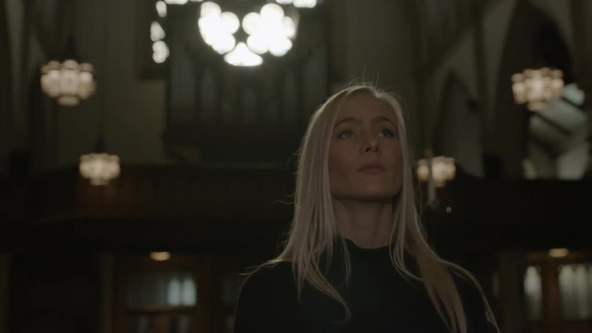 A woman is in a church looking up