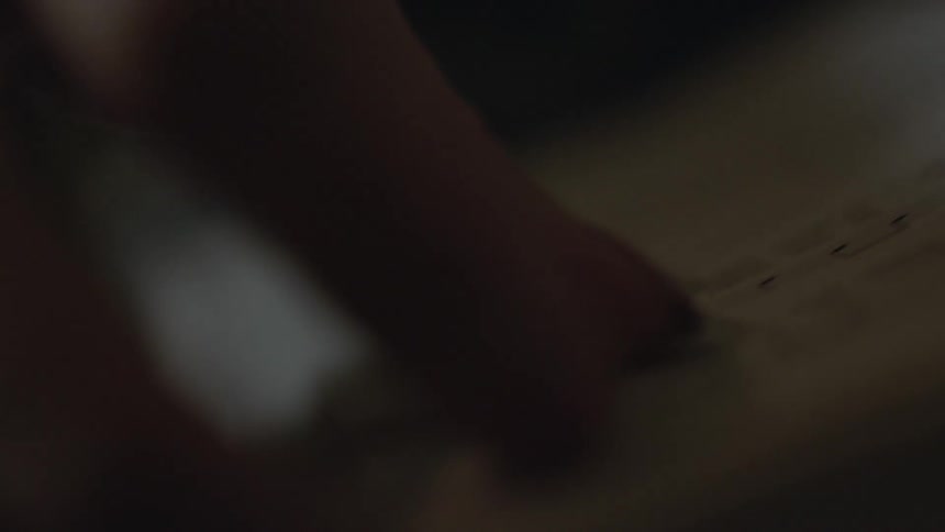 A hand is turning a page in a book
