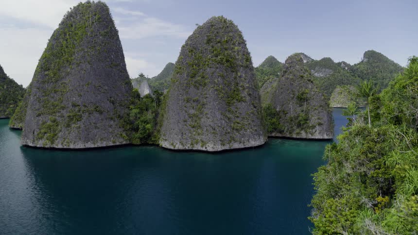 Aerial view of large island groups with sea cliffs surrounded by ocean