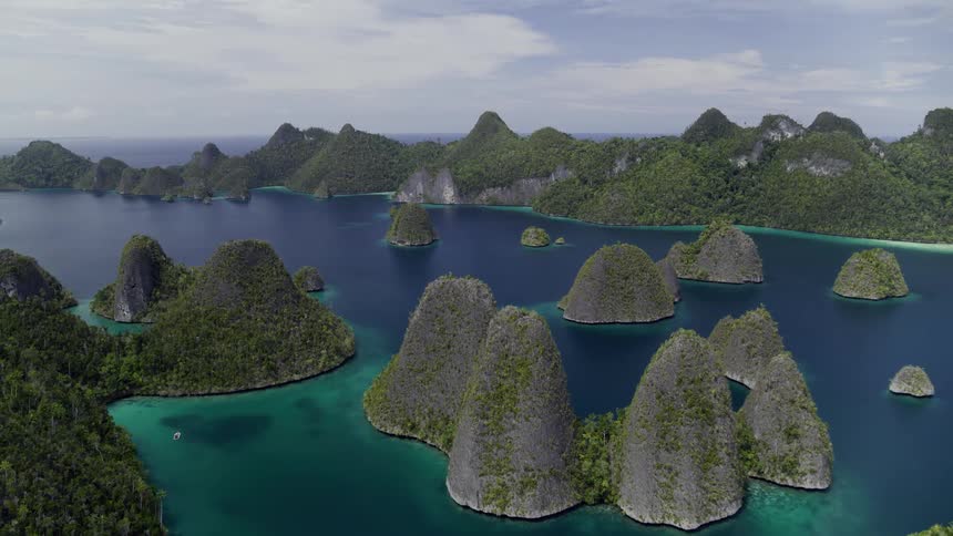 Several small islands sit off the coast of larger parcels of land in the ocean