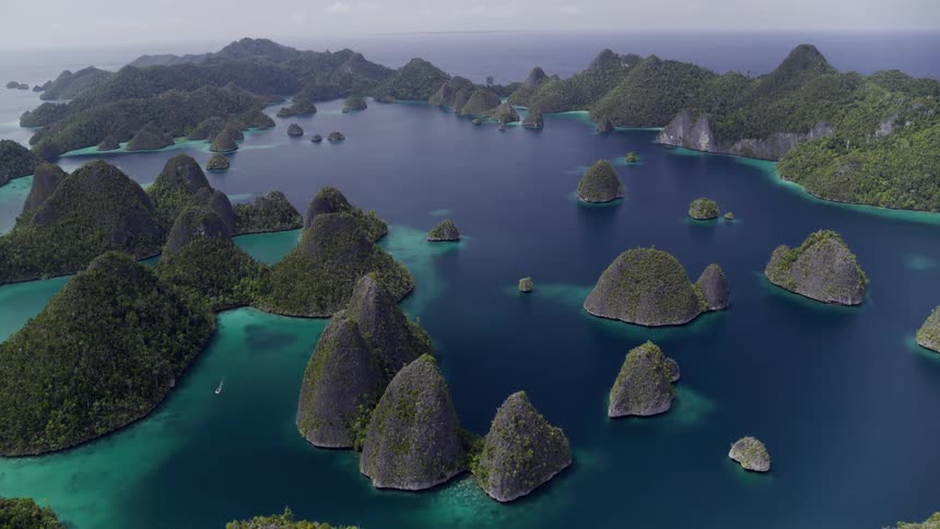 Aerial view of islands and an ocean is displayed
