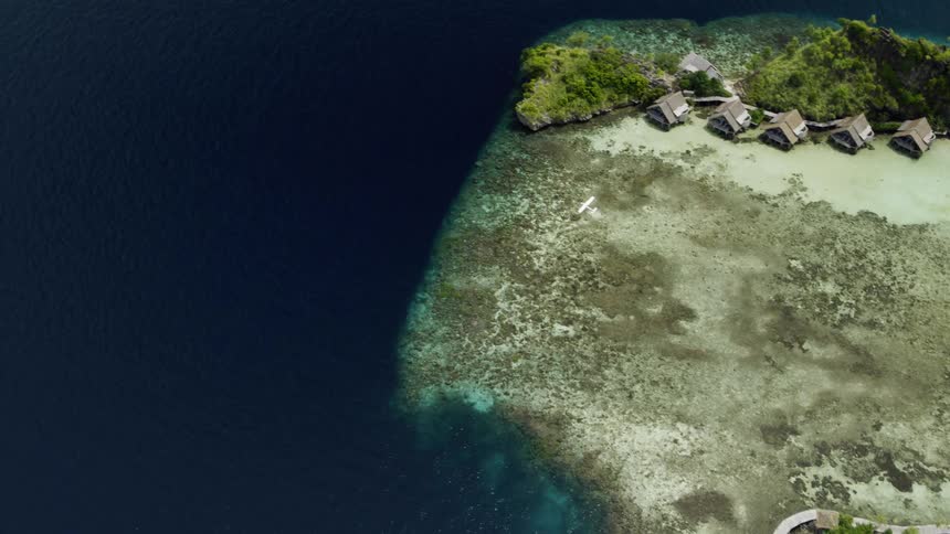 Plane flying above a remote island