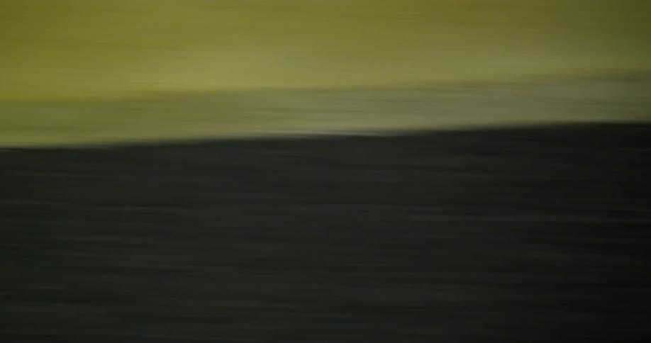 Close up of paved street moving fast with painted lines