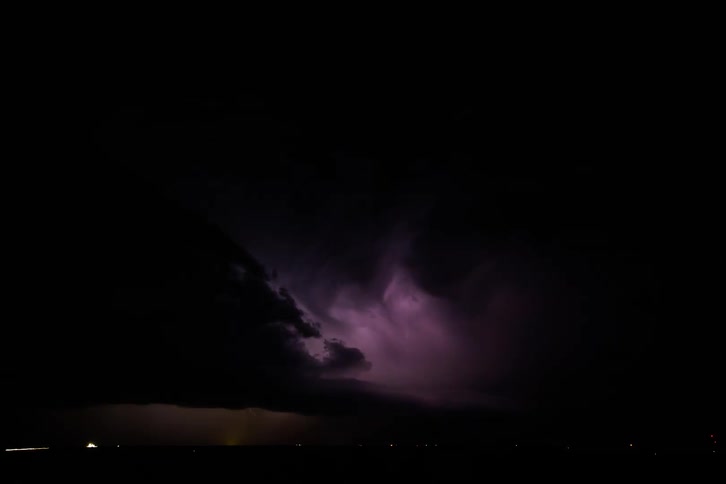Lightning flashes over a city at night