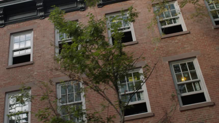 A brick building has some windows open