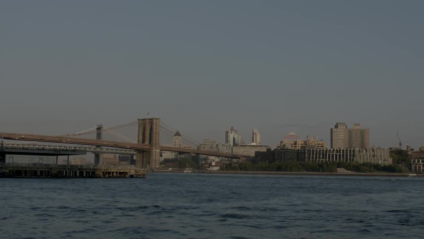 A bridge spans a body of water into a city