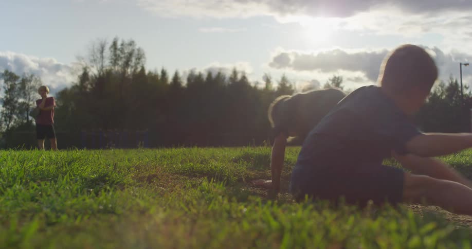 Two young boys playing together in a park