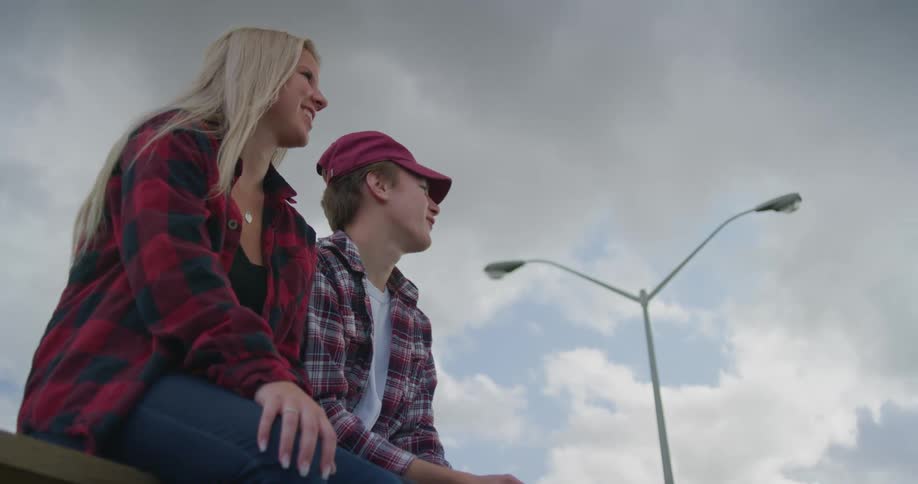 A man and woman are hanging outdoors together