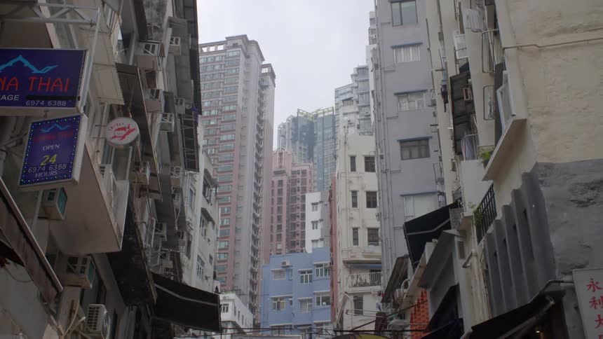 An empty city with tall buildings and storefronts