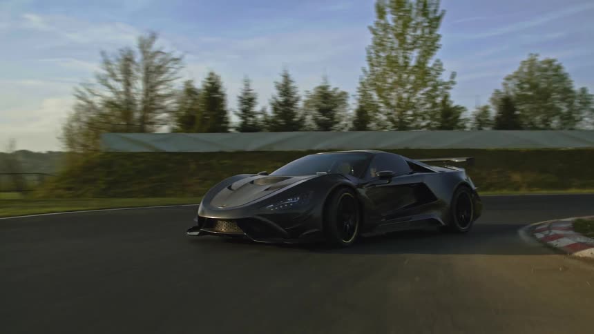 A car is driving on a racetrack in spring