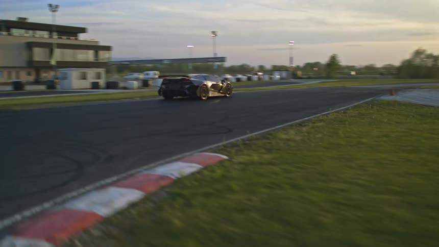 A car is driving on a race track