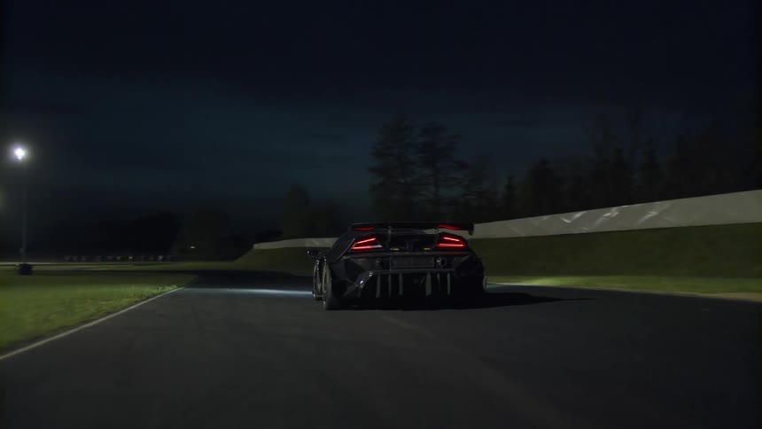 A luxury car drives on a track