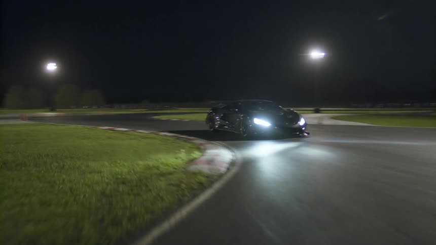 A sports car drives along a track