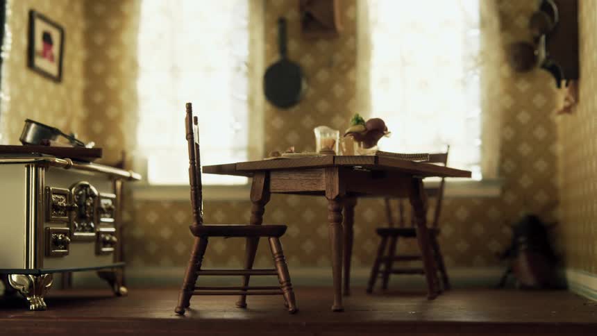 Cockroach crawls across the floor in a dollhouse kitchen