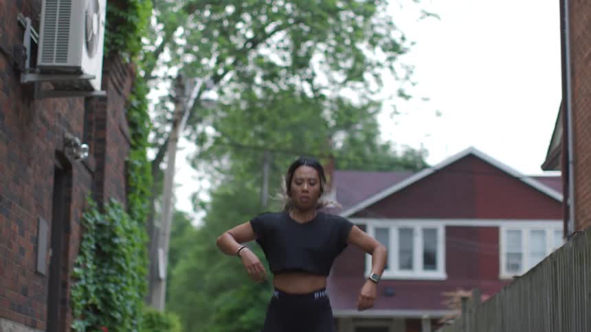 A teenage girl exercising in a neighborhood
