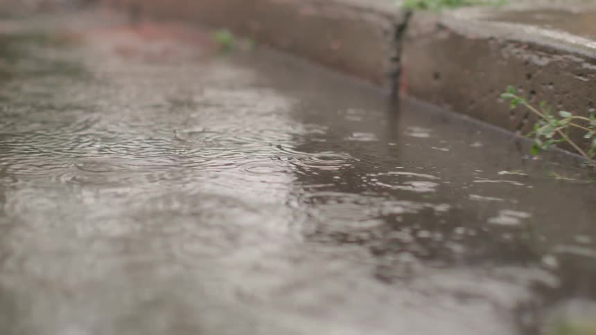 Rain falling and flooding a street