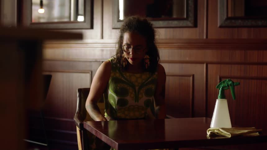 A woman wakes up stands from table looks nervous