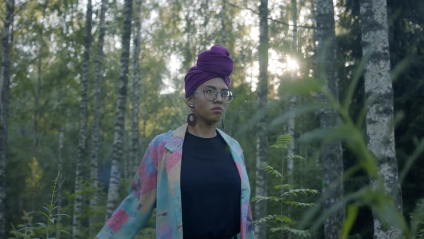 A teenage girl dancing in the forest