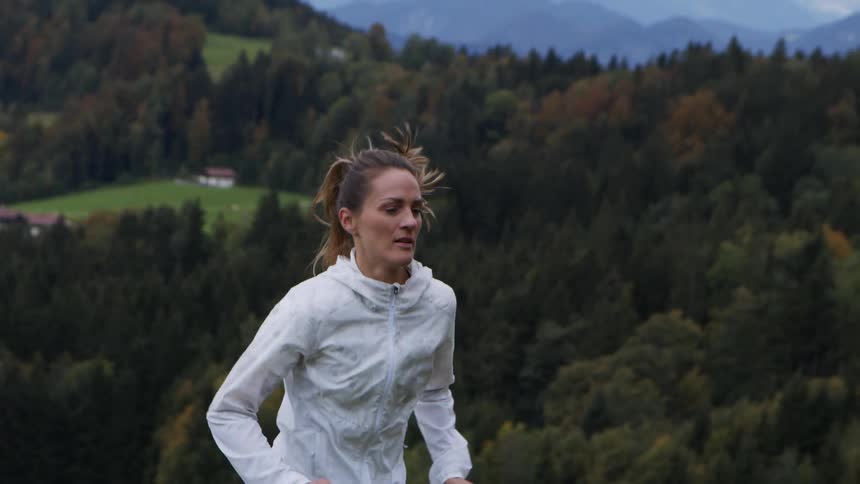 A woman is jogging outdoors in spring