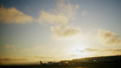 A plane flies while leaving an airport
