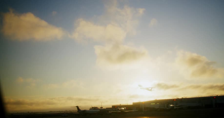A plane flies while leaving an airport