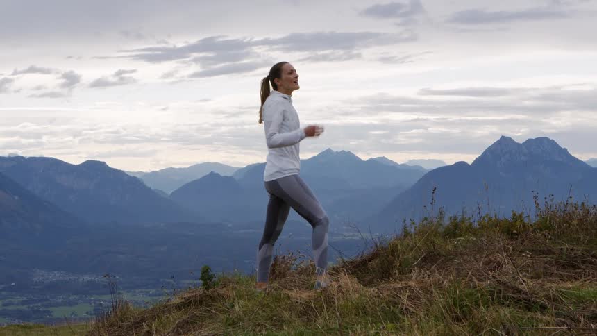 A woman is standing and looking at the landscape