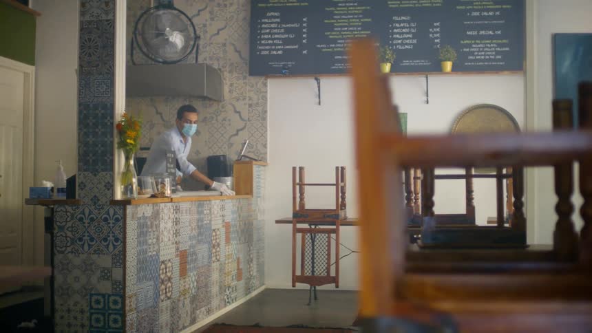 A man wipes down a counter