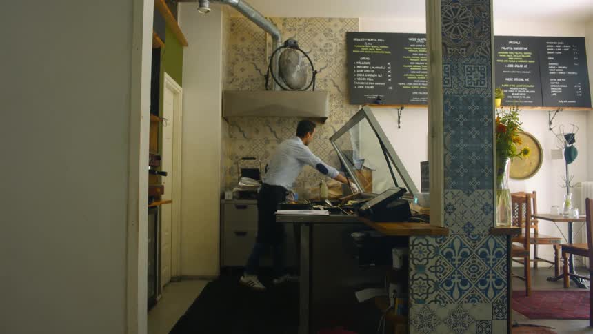 Man serving a customer in a cafe