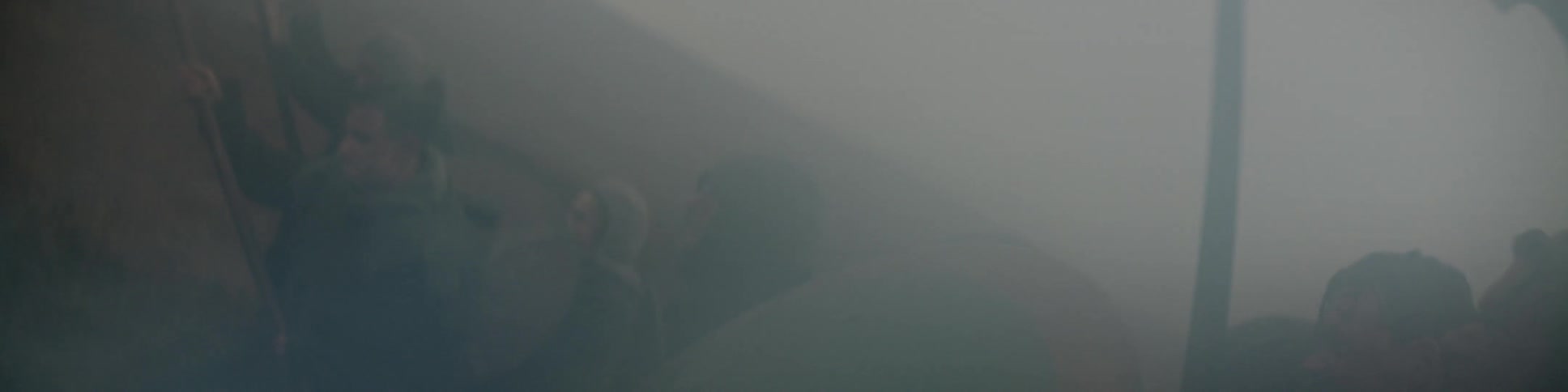 A group of people are fighting with weapons and shields