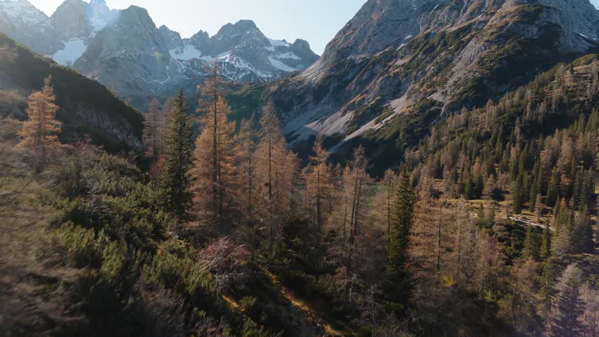 A lake is tucked into a valley between several tall mountains