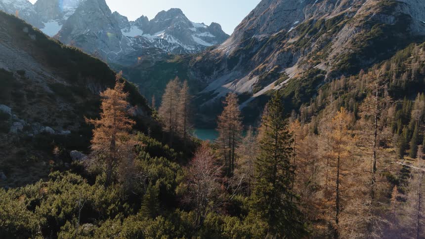 An aerial view of mountains forest and river during the day