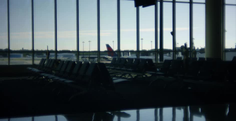 Empty rows of seats in an airport terminal waiting area