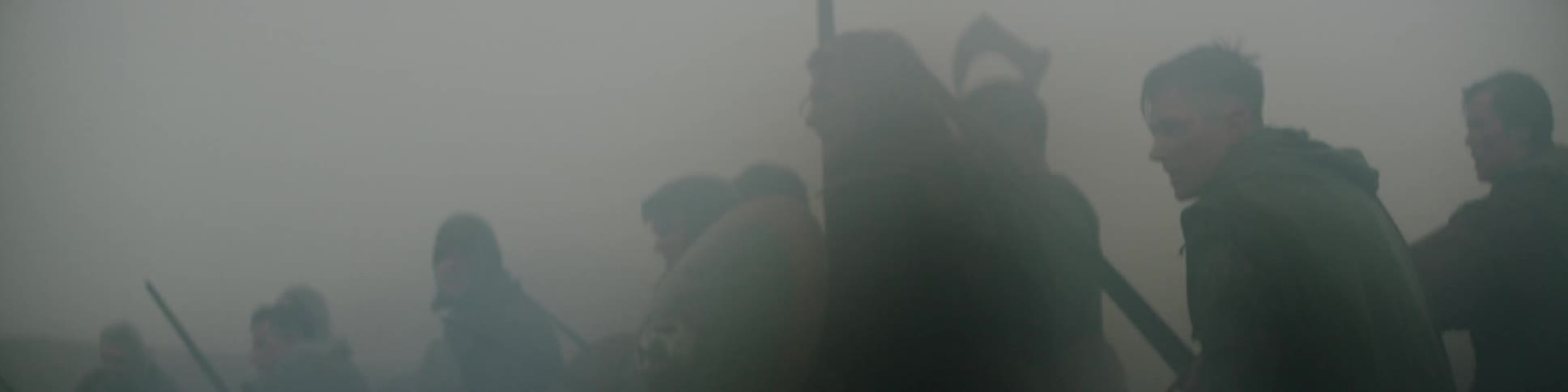 Men with swords and shields standing in dense fog