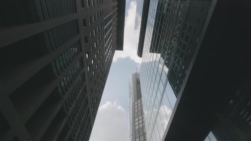 On the street are tall buildings that are very high in the sky