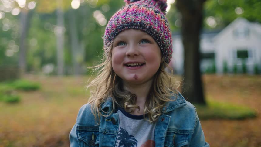 Young child smiling happily at camera