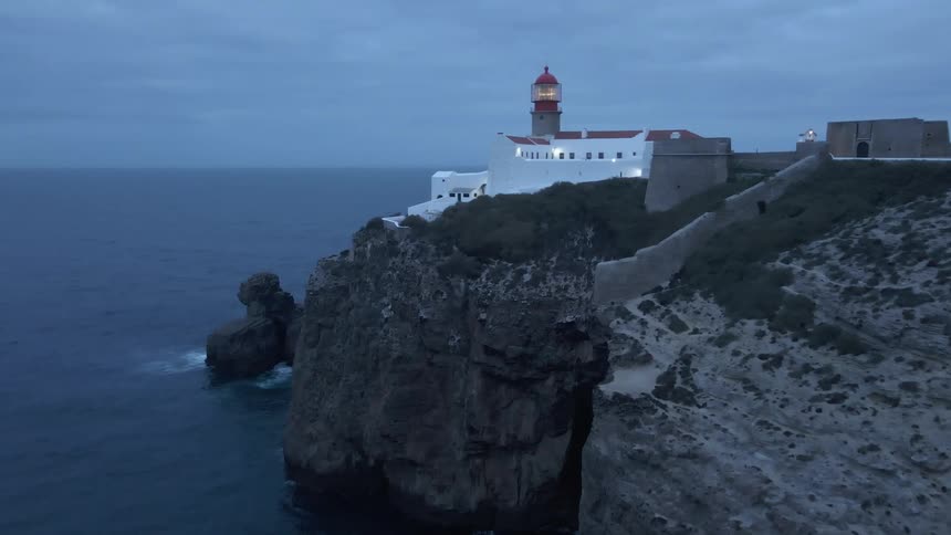Lighthouse casts light over the ocean on a cloudy day