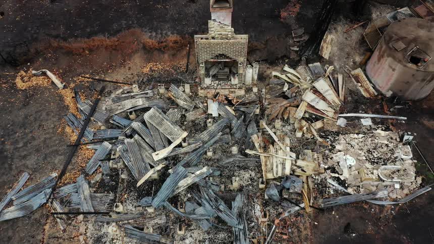 A lone fireplace remains of a house destroyed by fire