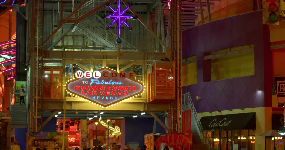 Downtown las vegas building at night time with people walking in and out and hanging around outside